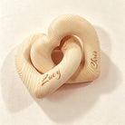 Close-up of engraved names on the interlocking wooden hearts
